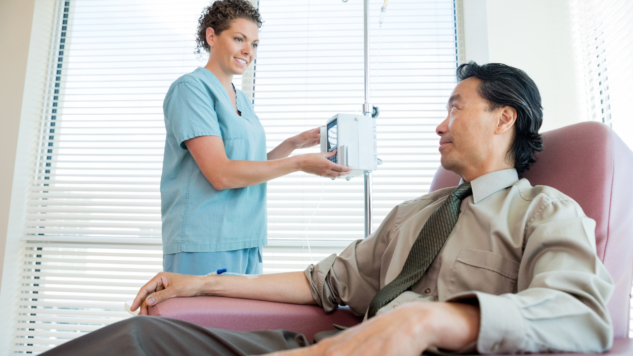 A nurse in scrubs prepares a Myers Cocktail IV for a man at a med spa in Hayden, Idaho, providing IV therapy in a bright clinic. at North Idaho Med Spa in Hayden