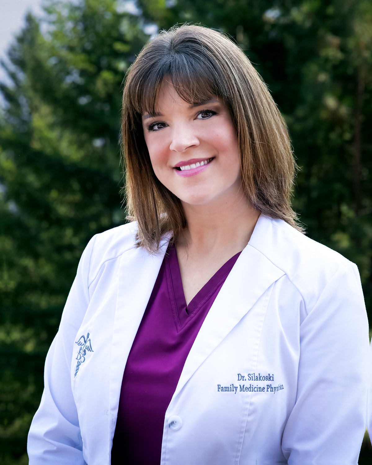 Dr. Stiakoski, Family Medicine Physician, smiles outdoors in a white coat, serving Med Spa clients in Hayden and Coeur d'Alene, Idaho. at North Idaho Med Spa in Hayden