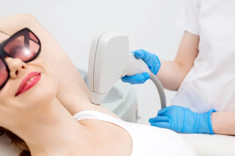 Laser hair removal on underarm at a med spa near Hayden, Idaho; technician wears blue gloves. RF microneedling, body contouring offered. at North Idaho Med Spa in Hayden