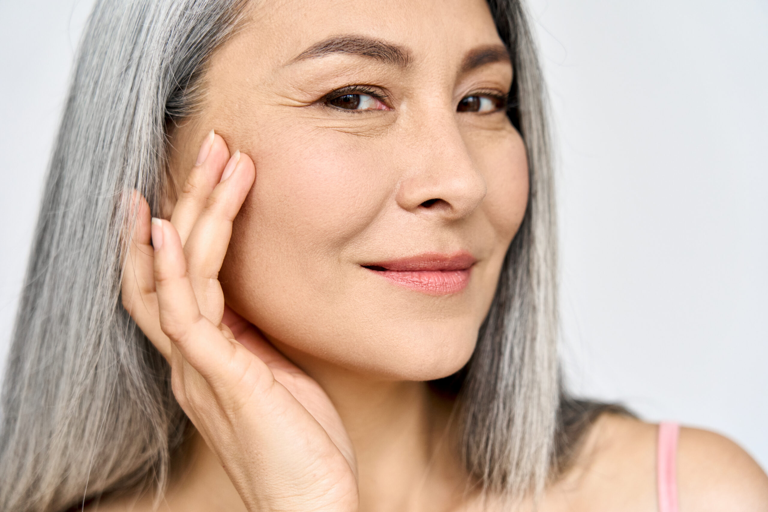 Close-up of woman with long gray hair smiling post-RF microneedling at a Med Spa in Hayden, Idaho, showing renewed confidence. at North Idaho Med Spa in Hayden